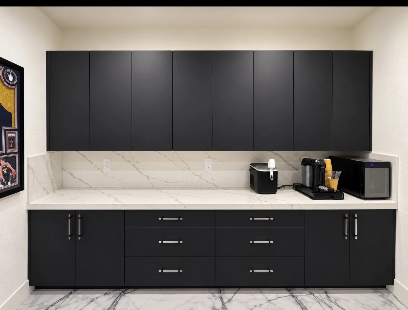 Black upper and lower beverage-station cabinetry with a light veined counter and backsplash.