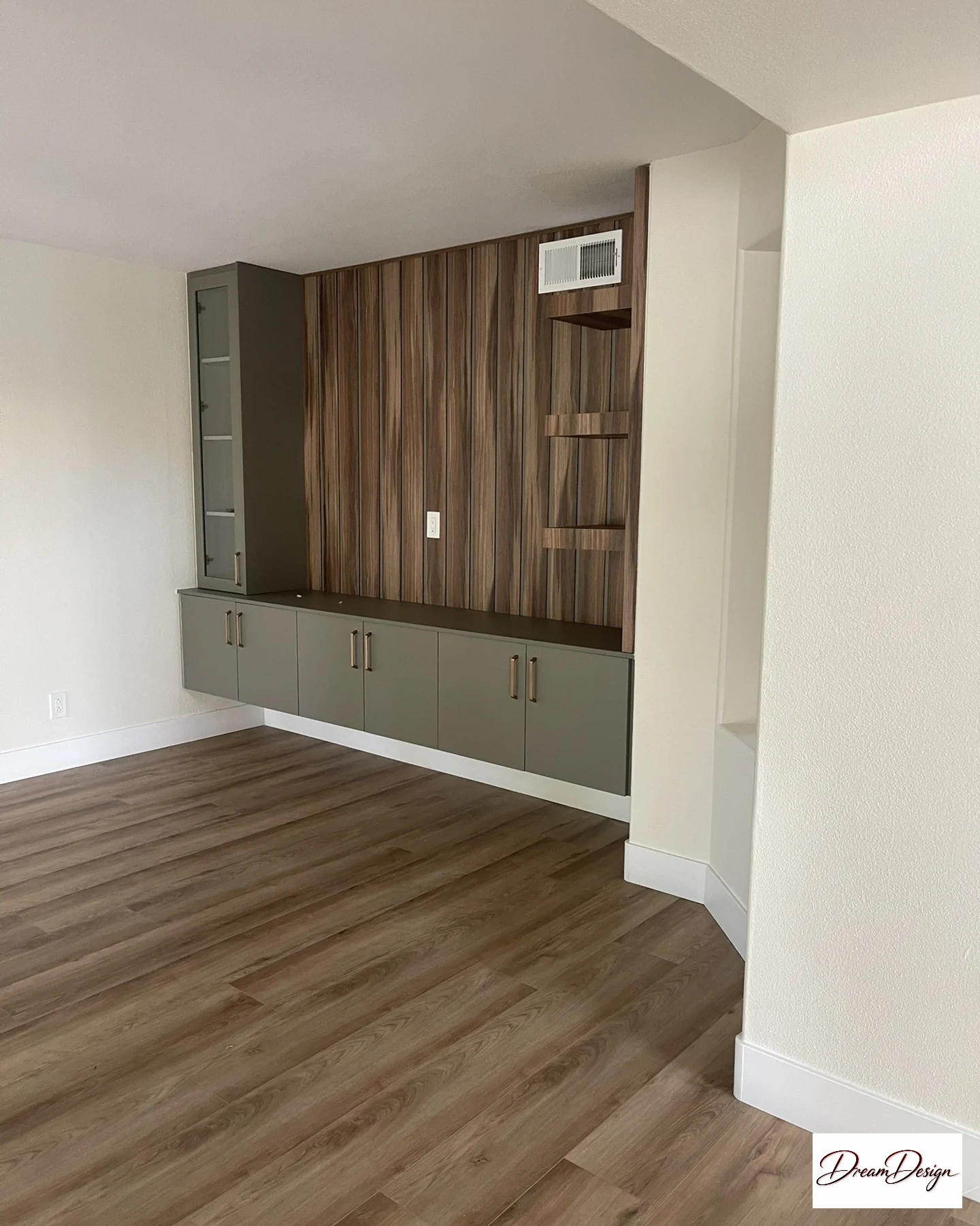 Floating storage cabinets below vertical wood-look paneling, a glazed cabinet and open shelves.